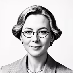 a black and white image of a woman wearing glasses