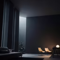 there is a black living room with chairs and light in it
