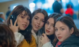 a group of pretty young women holding up cellphones