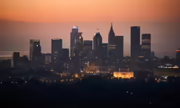 a city skyline is lit up with lights