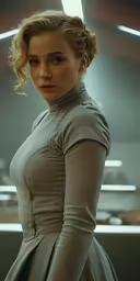a woman is standing in the dark with her hands on her hips