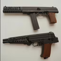two guns lying next to each other on a white surface