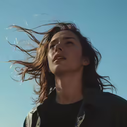a woman with her hair flying in the wind
