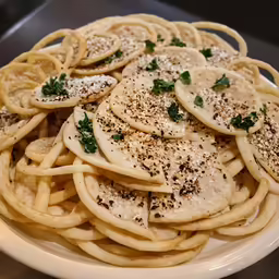 this is a plate full of food with cheese and pepper