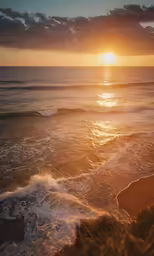 the sun is setting in the ocean on the shore