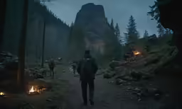 several people walking on the path near a mountain