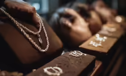 a person with long necklaces on display