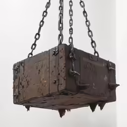 the large brick box is attached to chains
