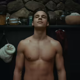 a man with his bare body looking up