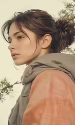 an attractive woman with a jacket and hair bun