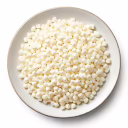 a plate of white cake dough on a white table