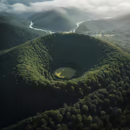 the mountains are covered in green vegetation and clouds