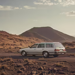 a car parked in the middle of a dirt field
