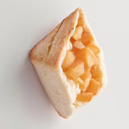 a white and orange dessert item is cut in half