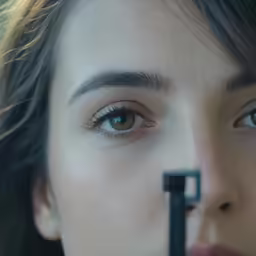 a woman with blue eyes has the camera in front of her