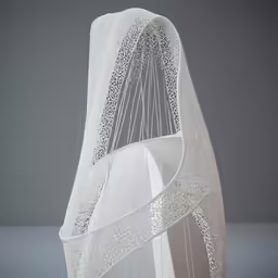 the top part of a white veil made from paper