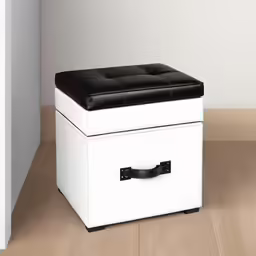 an ottoman that has a black leather seat