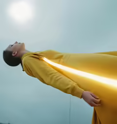 a woman in yellow holding the neck of a car