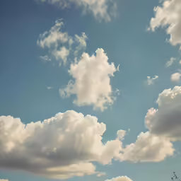 white clouds in the blue sky with a helicopter