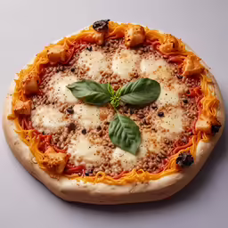 a cheese and basil pizza sitting on top of a table