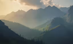 the sun shining on a grassy mountain range