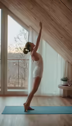 a person on a yoga mat, doing an upward angle