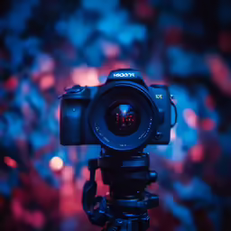 a red and blue camera on top of a tripod