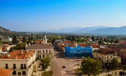 the buildings are painted blue in an area surrounded by hills