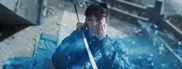 asian male in blue coat holding a sword with smoke coming out of it