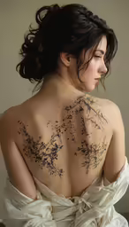 a woman is wearing a dress with tattoos