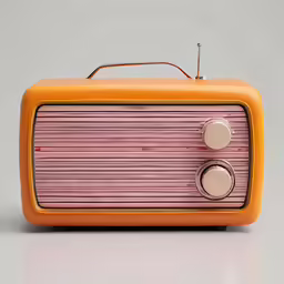 an orange and pink radio on top of a white table