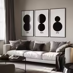 a living room with furniture and paintings above it