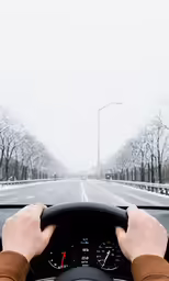 a man driving his car through the snow