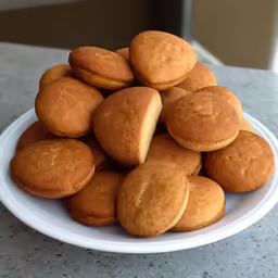several small cookies on a white plate