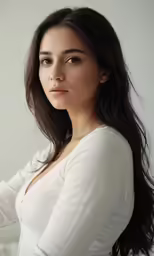 a women in white looking straight ahead and to her left