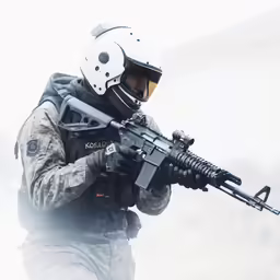 the soldier is holding a machine gun