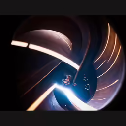a worker welding inside a large metal object
