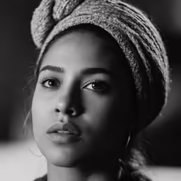 a woman with a turban on and wearing a ring