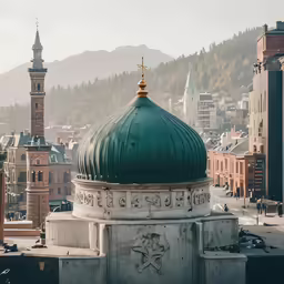 a domed green building with a gold spire and clock on the front of it
