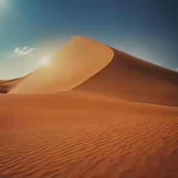 the sun shining on top of a dune with clouds