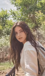 a girl poses in a field in the sun