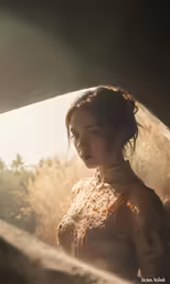 a beautiful woman wearing a wedding gown with a veil on