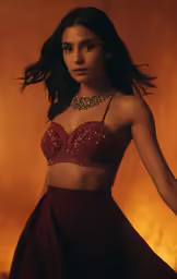 the girl is wearing a halter top and skirt