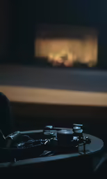 a remote sitting on top of a table near a fire place