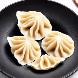 the three dumplings are in a pan on the stove top