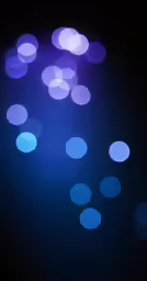 a bright blue object is glowing on a black background