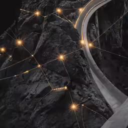 the image shows many lights and lines along the side of a mountain