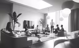 people are sitting in the living room and talking