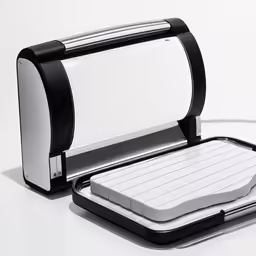 an electric sandwich maker is open and ready to be used