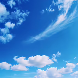 a blue sky filled with lots of white clouds